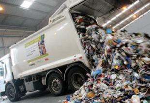 Waste truck tipping rubbish from trailer