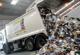 Waste truck tipping rubbish from trailer