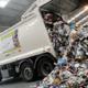 Waste truck tipping rubbish from trailer