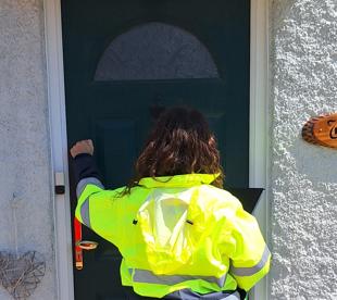 Volunteer knocking on a door